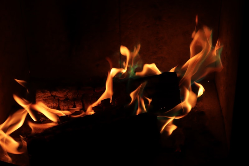 Realistic gas log set burning in a traditional fireplace