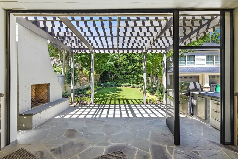 Cedar pergola over a stone patio in a Loudoun County backyard